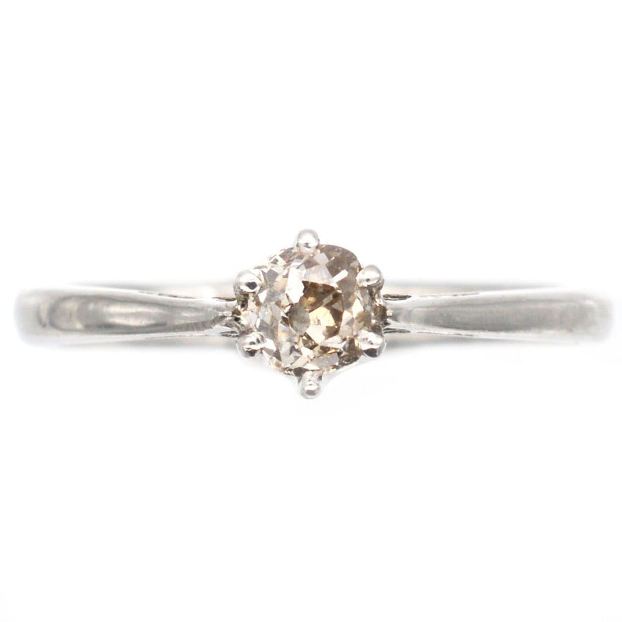 Art Deco platinum solitaire ring featuring a cognac diamond, perfect for engagement or special occasions.