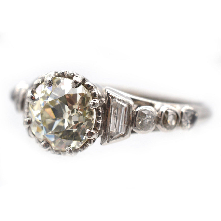 Art Deco platinum large diamond solitaire ring with diamond shoulders, vintage design circa 1925, featuring unique cuts.