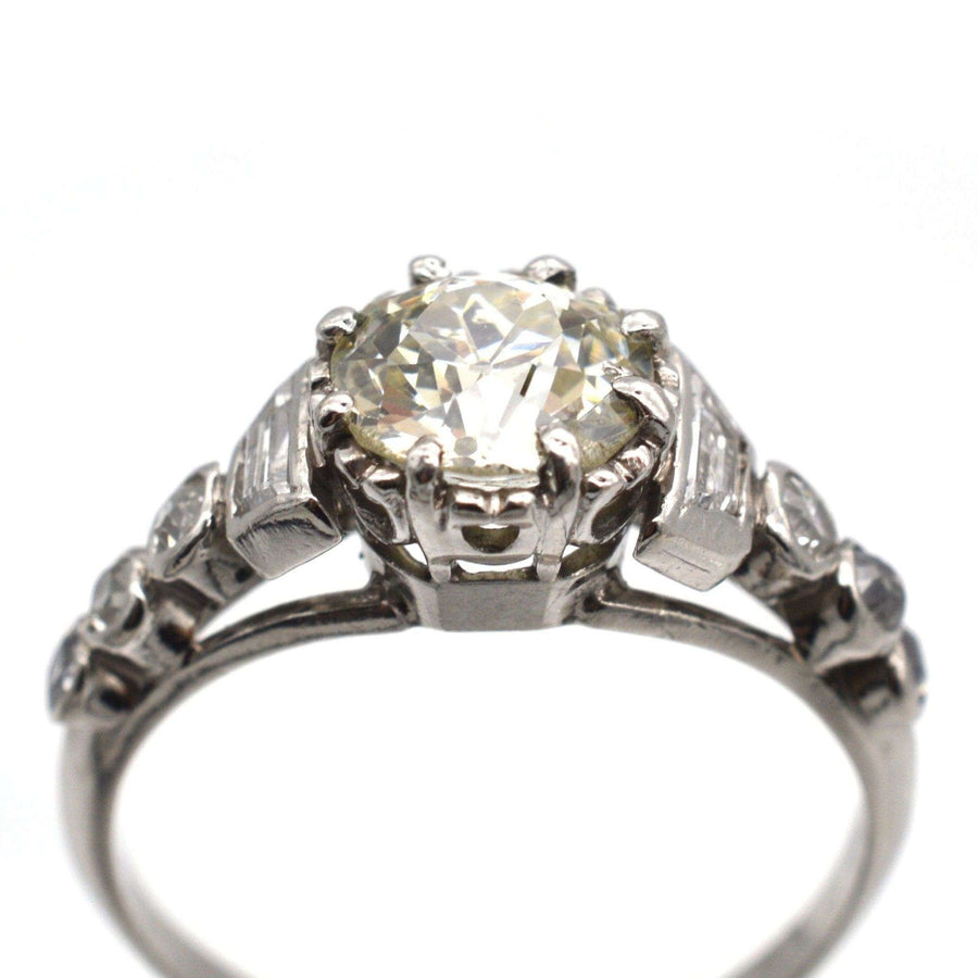 Art Deco platinum diamond solitaire ring with diamond shoulders, made circa 1925, showcasing exquisite craftsmanship.