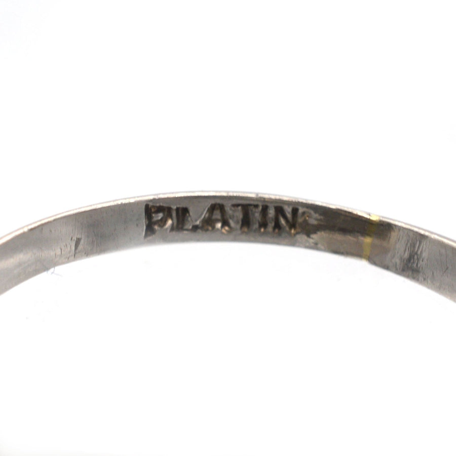 Close-up of a platinum ring band showcasing the engraving of "PLATIN" for authenticity.