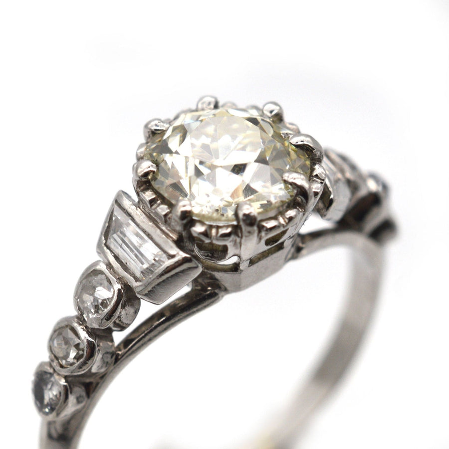 Art Deco platinum large diamond solitaire ring with diamond shoulders, circa 1925, featuring unique cuts of diamonds.