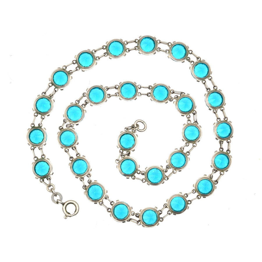Art Deco silver necklace featuring lustrous blue paste stones in riviere design, perfect for vintage jewelry lovers.