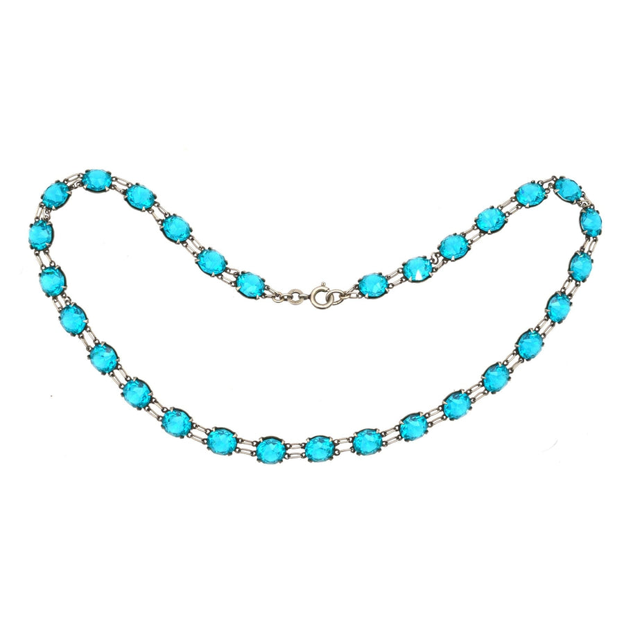 Art Deco silver necklace featuring lustrous blue paste stones set in sterling silver with double ring links.