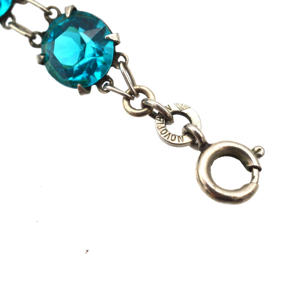 Art Deco silver necklace featuring lustrous blue paste stones in a riviere design with double ring links.