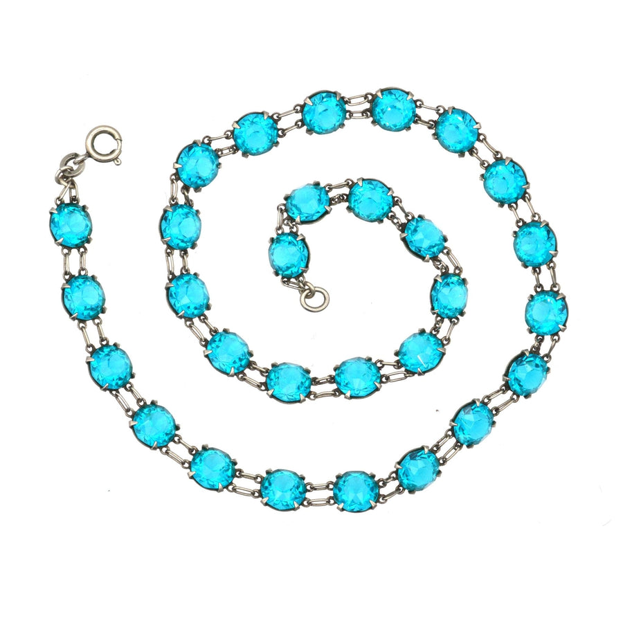Art Deco silver necklace with lustrous blue paste stones, featuring double ring links for added elegance.