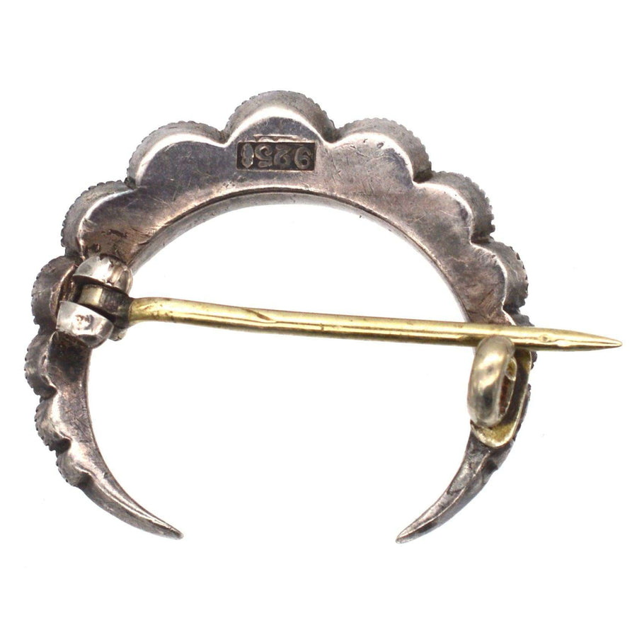 Back view of a vintage Art Deco silver crescent moon brooch with a secure pin clasp, showcasing intricate detailing.