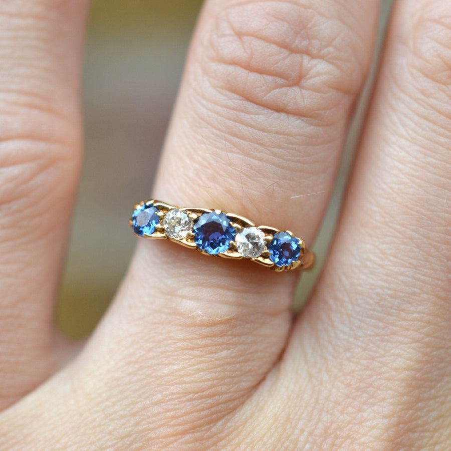 Edwardian 15ct gold five stone ring featuring cornflower sapphires and diamonds, perfect for engagements.