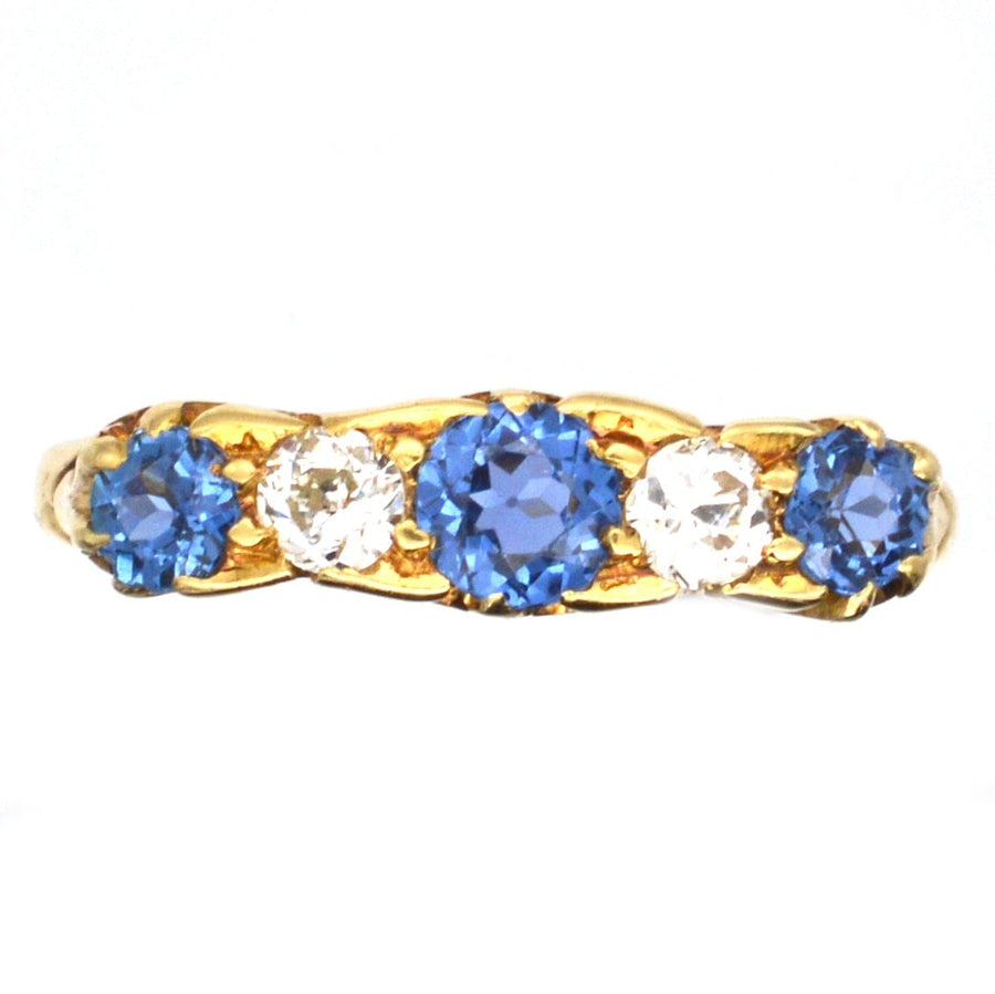 Edwardian 15ct gold five stone ring featuring blue sapphires and diamonds, perfect for engagement.