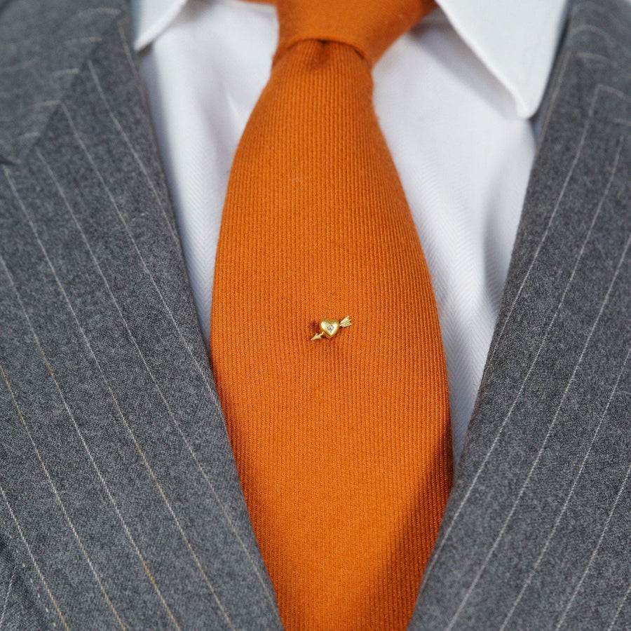 Edwardian 15ct gold heart and arrow tie pin with rose diamond on orange tie.
