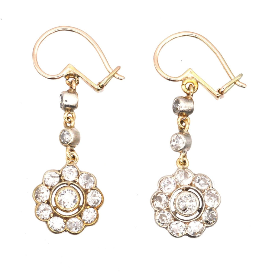 Edwardian 18ct gold diamond cluster drop earrings featuring floral design and sparkling diamonds.