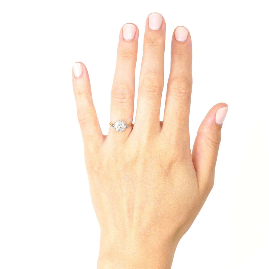 Edwardian 18ct gold and diamond cluster ring displayed on a hand, showcasing its elegant design and comfortable fit.