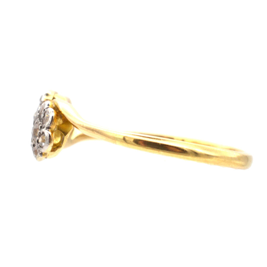 Edwardian 18ct gold crossover ring featuring two diamond flowers, symbolizing love and elegance.