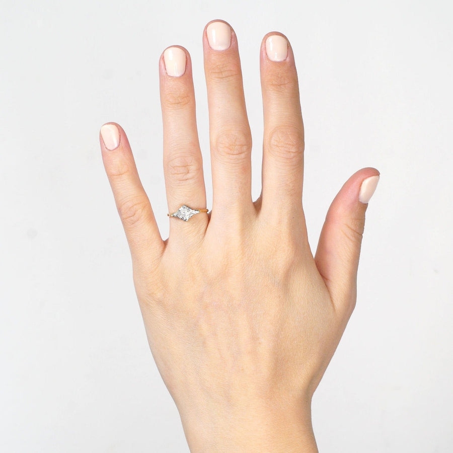 Elegant Edwardian 18ct gold and platinum diamond cluster ring showcased on a woman's hand.