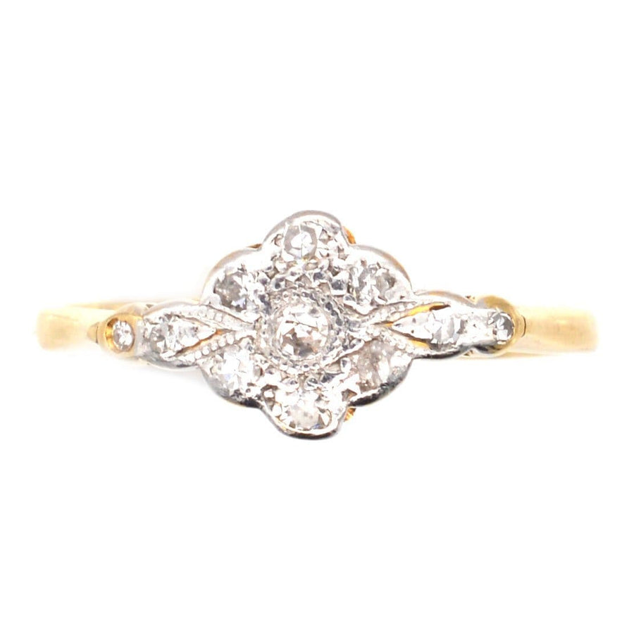 Edwardian 18ct gold and platinum diamond cluster ring with intricate design and 0.20 carats of diamonds.