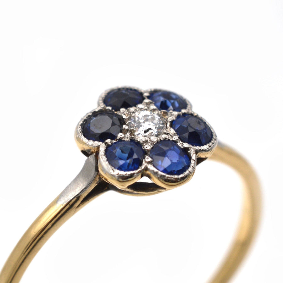 Edwardian 18ct gold and platinum sapphire and diamond flower cluster ring with six vibrant sapphires.