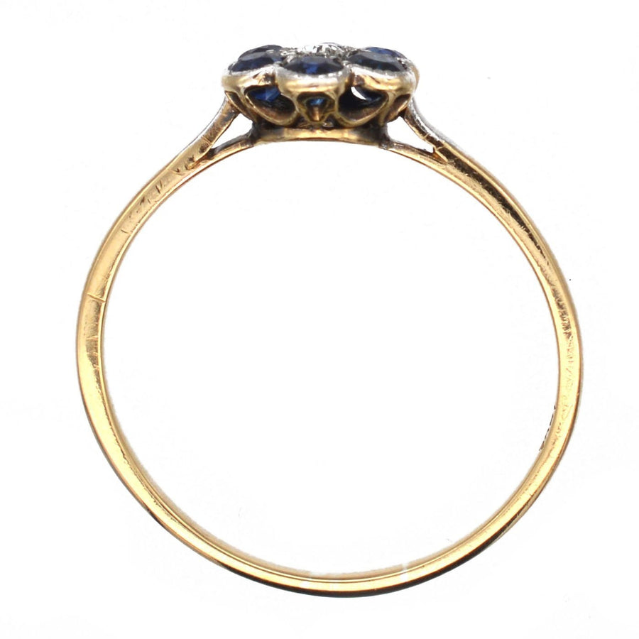Edwardian 18ct gold and platinum flower cluster ring featuring sapphires and diamond, dating circa 1910.