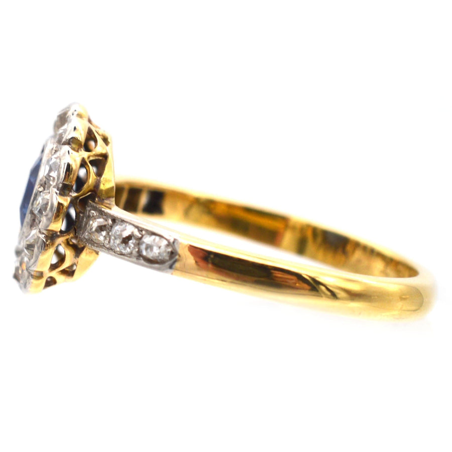 Edwardian 18ct gold sapphire and diamond cluster ring, showcasing royal blue sapphire and diamond shoulders.