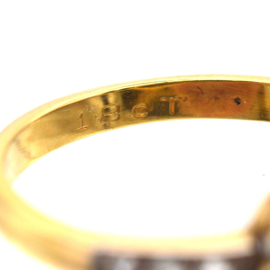 Close-up of 18ct gold hallmark inside an Edwardian sapphire and diamond cluster ring.