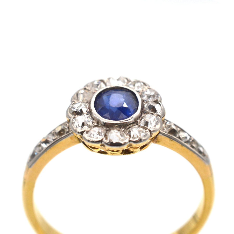 Edwardian 18ct gold sapphire and diamond cluster ring, circa 1910, featuring a royal blue sapphire and old cut diamonds.