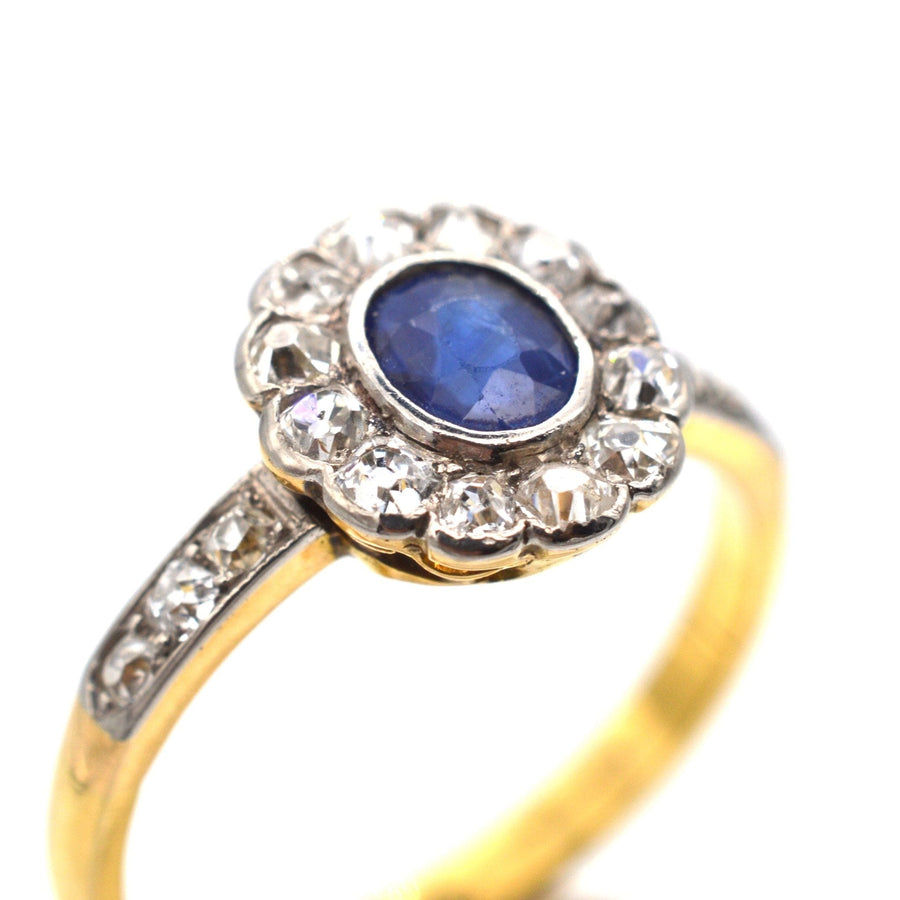 Edwardian 18ct gold sapphire and diamond cluster ring with diamond shoulders, circa 1910.