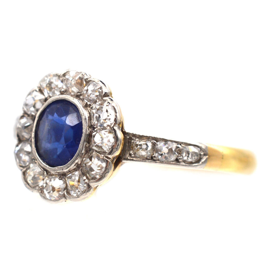 Edwardian 18ct gold sapphire and diamond cluster ring with diamond shoulders, circa 1910, royal blue sapphire.