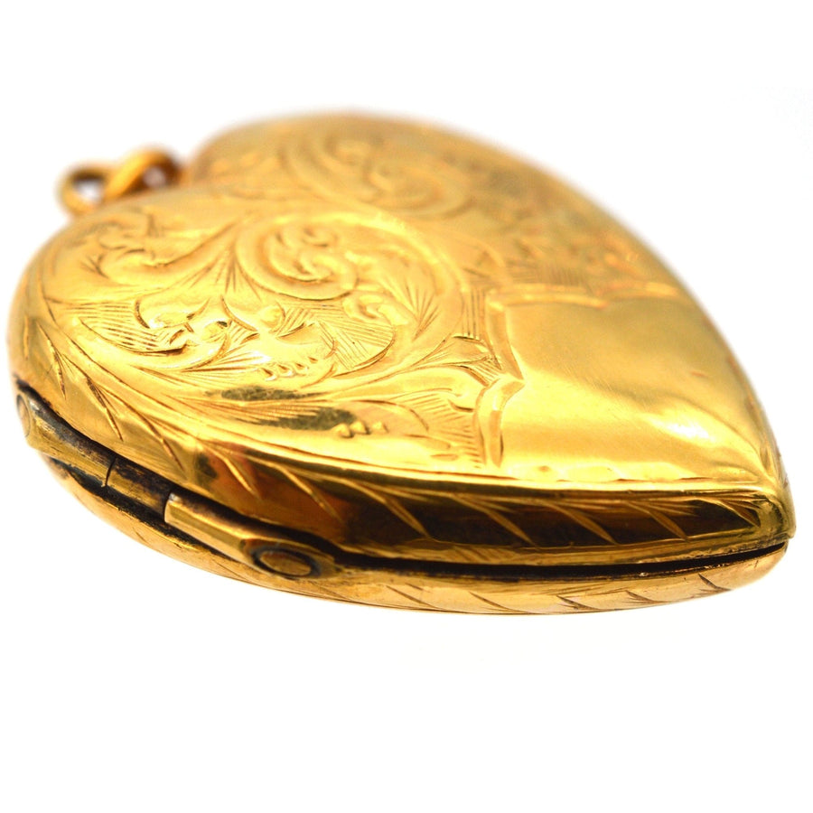 Edwardian 9ct gold heart locket pendant with engraved scroll motifs, circa 1900-1910.