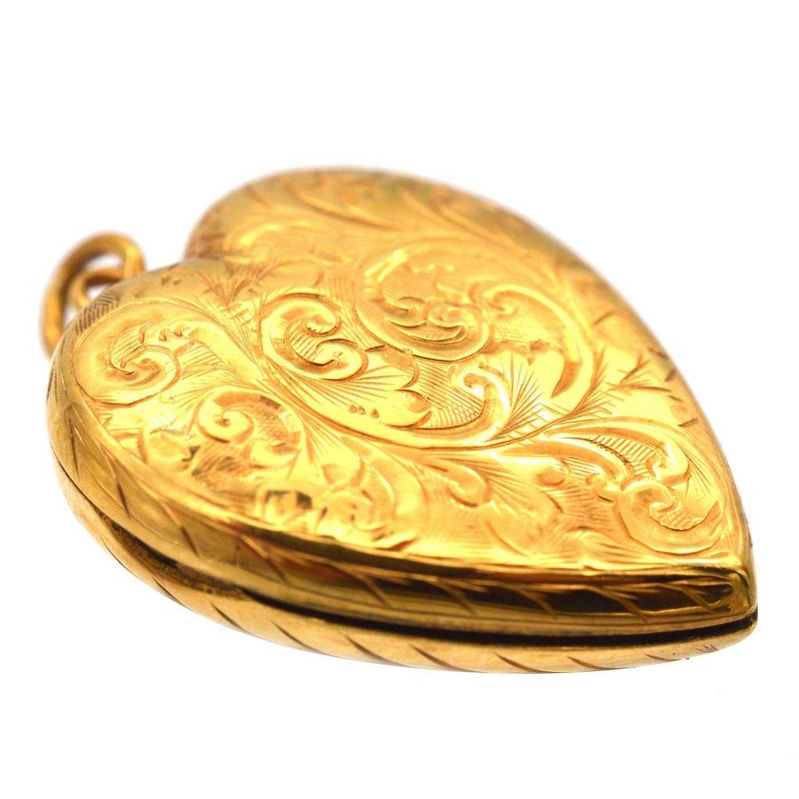 Edwardian 9ct gold heart locket pendant with elegant engraved scroll motifs, circa 1900-1910.