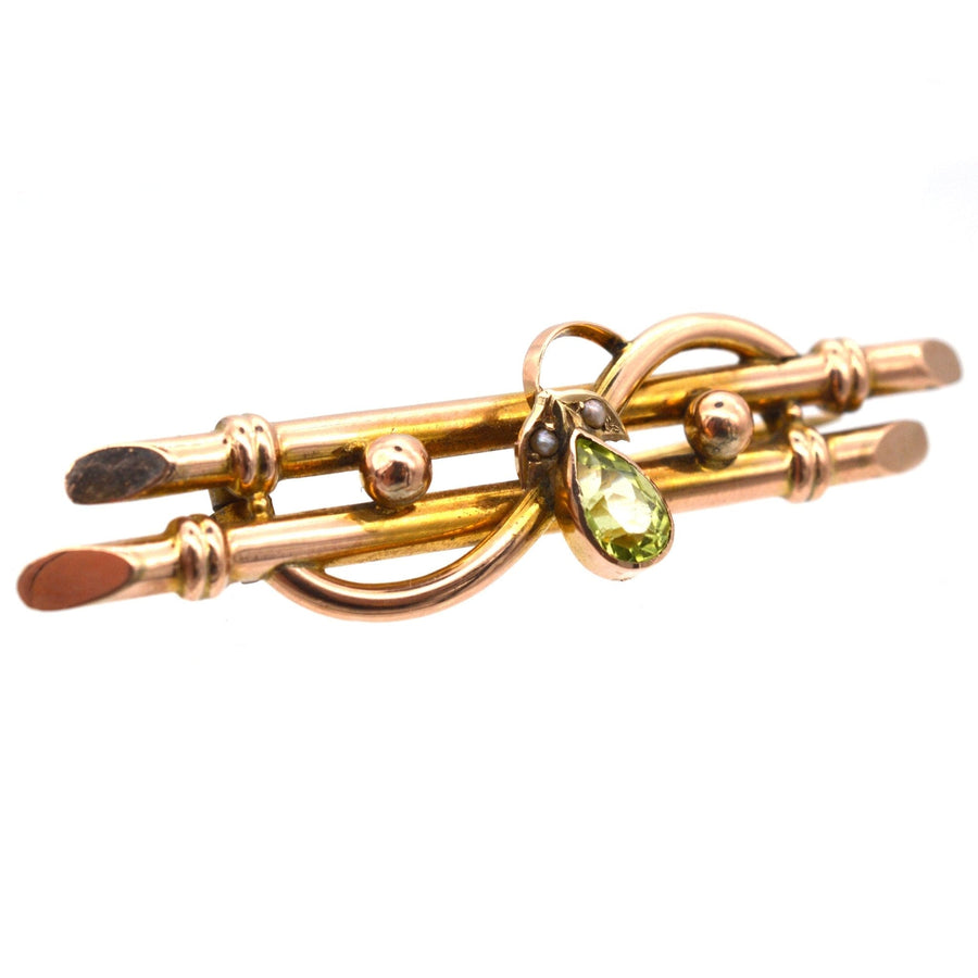 Edwardian 9ct gold bar brooch featuring a pear shape peridot and seed pearls, circa 1900-1910.
