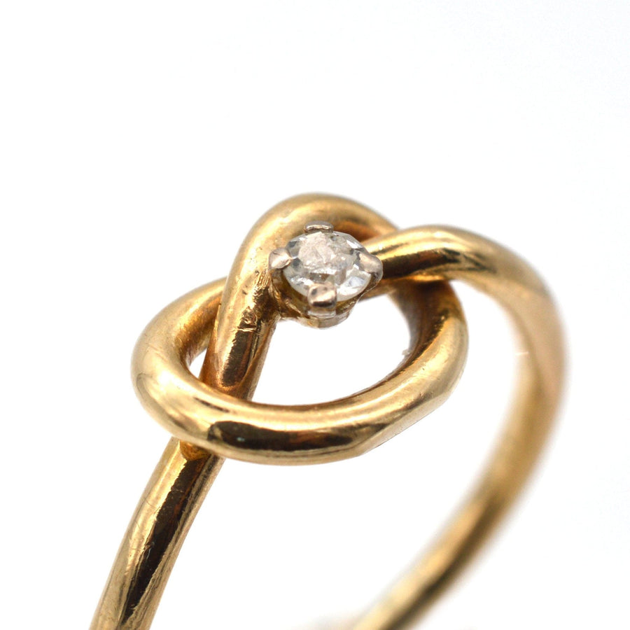Elegant 9ct gold lovers' knot ring featuring a sparkling diamond, symbolizing infinite love.