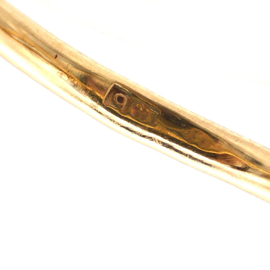 Close-up of the inner band of a 9ct gold ring showing the hallmark for authenticity.