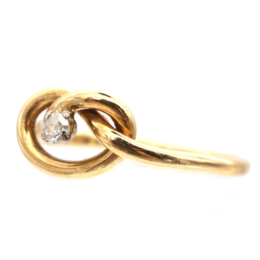 Elegant 9ct gold lover's knot ring with a sparkling diamond, symbolizing infinite love and unbreakable bonds.