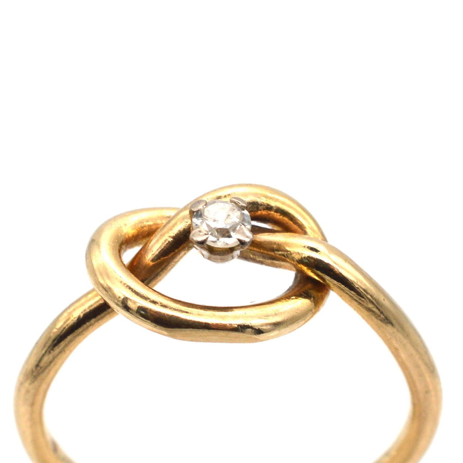 Elegant 9ct gold lover's knot ring featuring a sparkling diamond center, symbolizing infinite love.