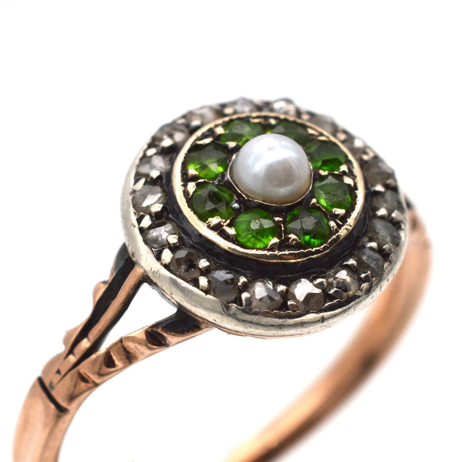 Edwardian 9ct gold target ring with green garnets, diamond halo, and natural pearl center, vintage design.
