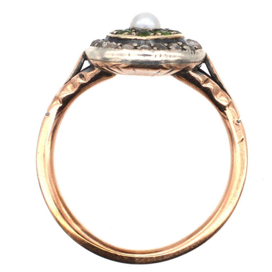 Edwardian 9ct gold target ring featuring green garnets, diamonds, and a central pearl, showcasing antique craftsmanship.