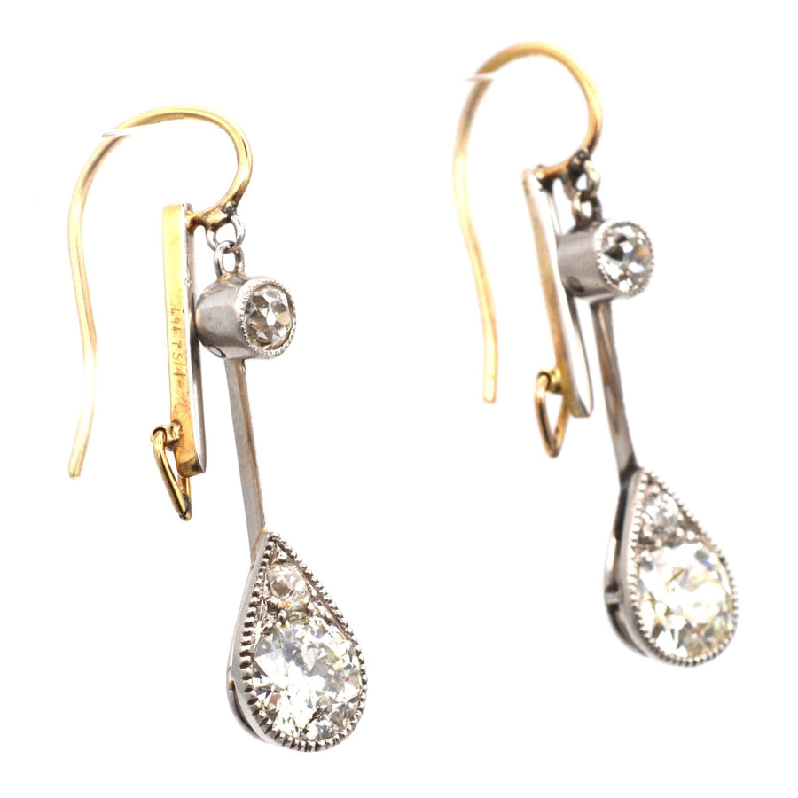 Edwardian platinum and 18ct gold diamond drop earrings featuring old cut diamonds in pear-shaped settings.