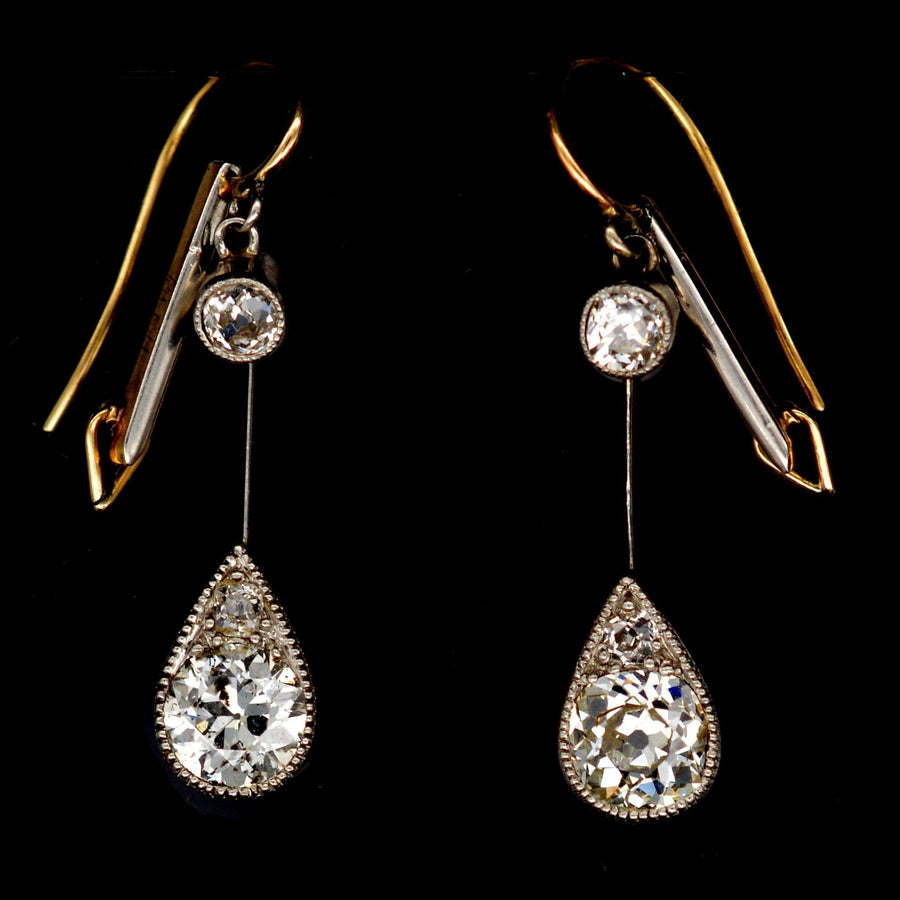 Edwardian platinum and 18ct gold diamond drop earrings with pear-shaped setting and old cut diamonds.