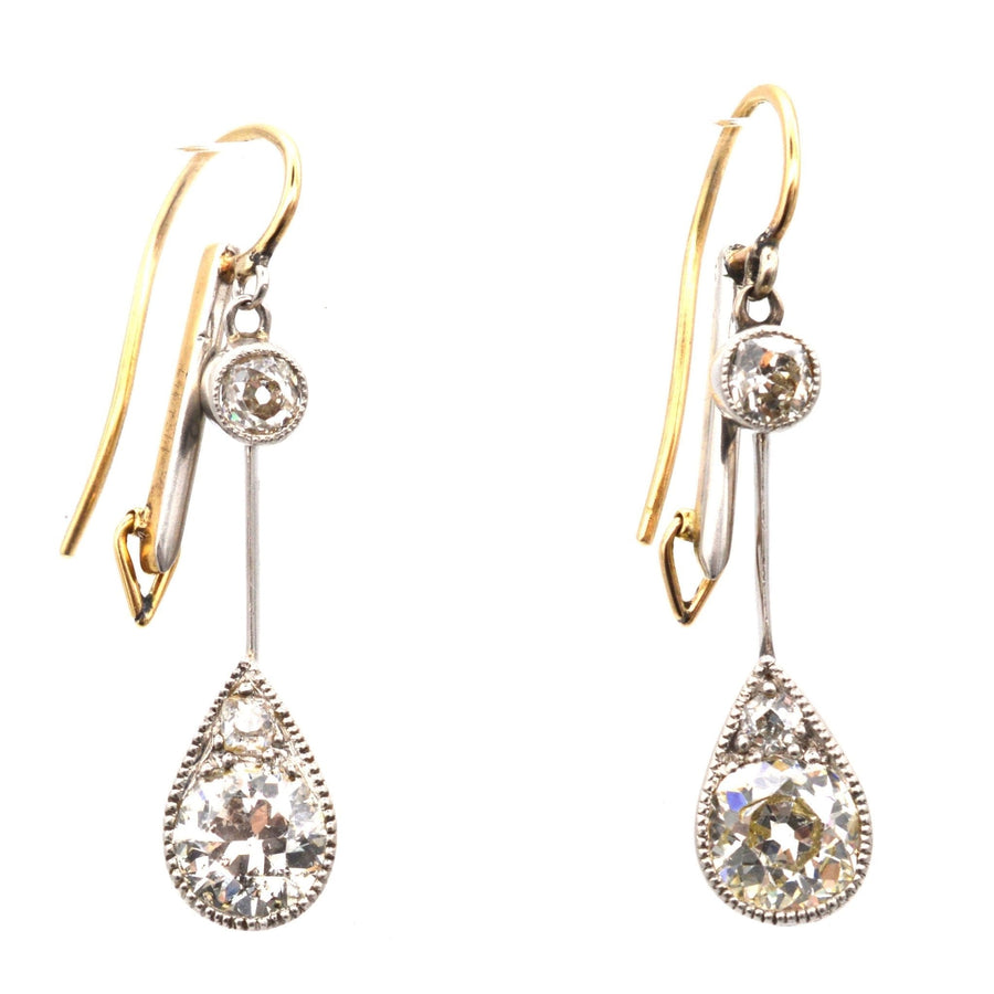 Edwardian platinum and 18ct gold diamond drop earrings with pear-shaped design and vintage appeal.