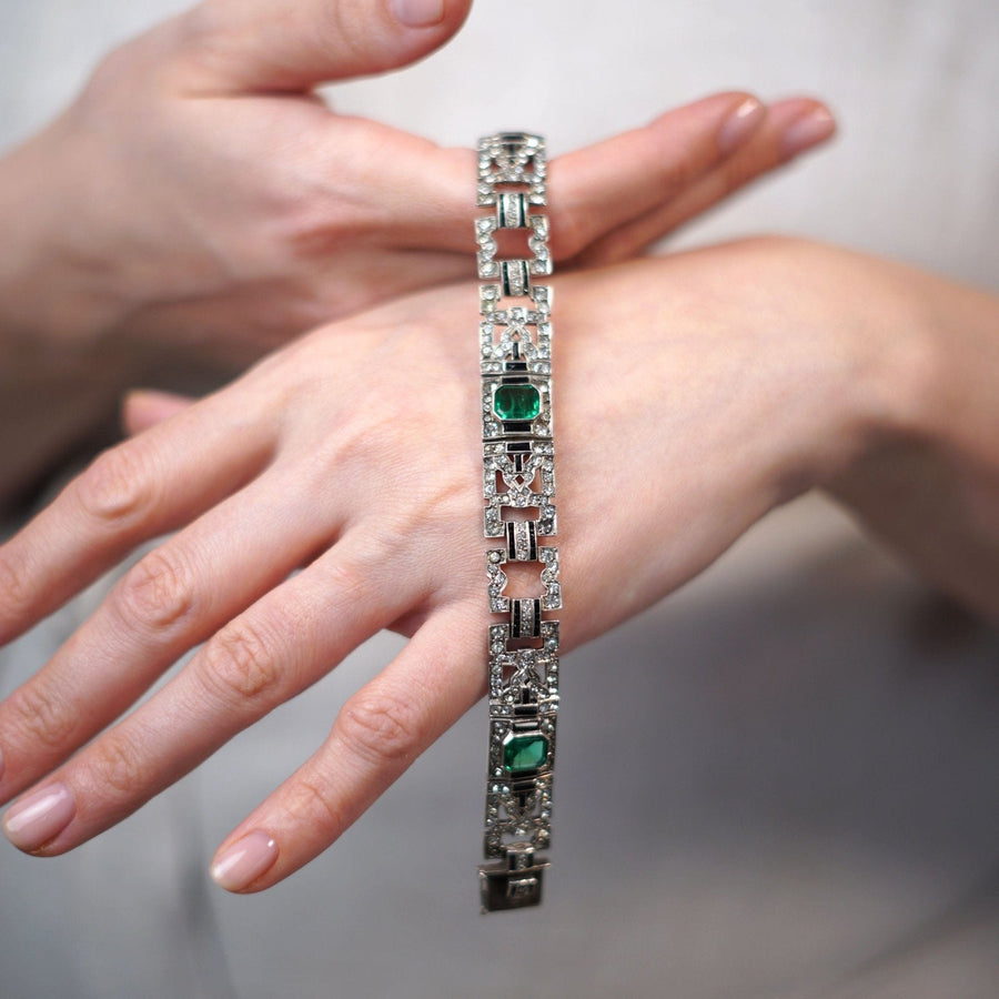 Elegant French Art Deco bracelet featuring emerald green and diamond paste on a hand model.