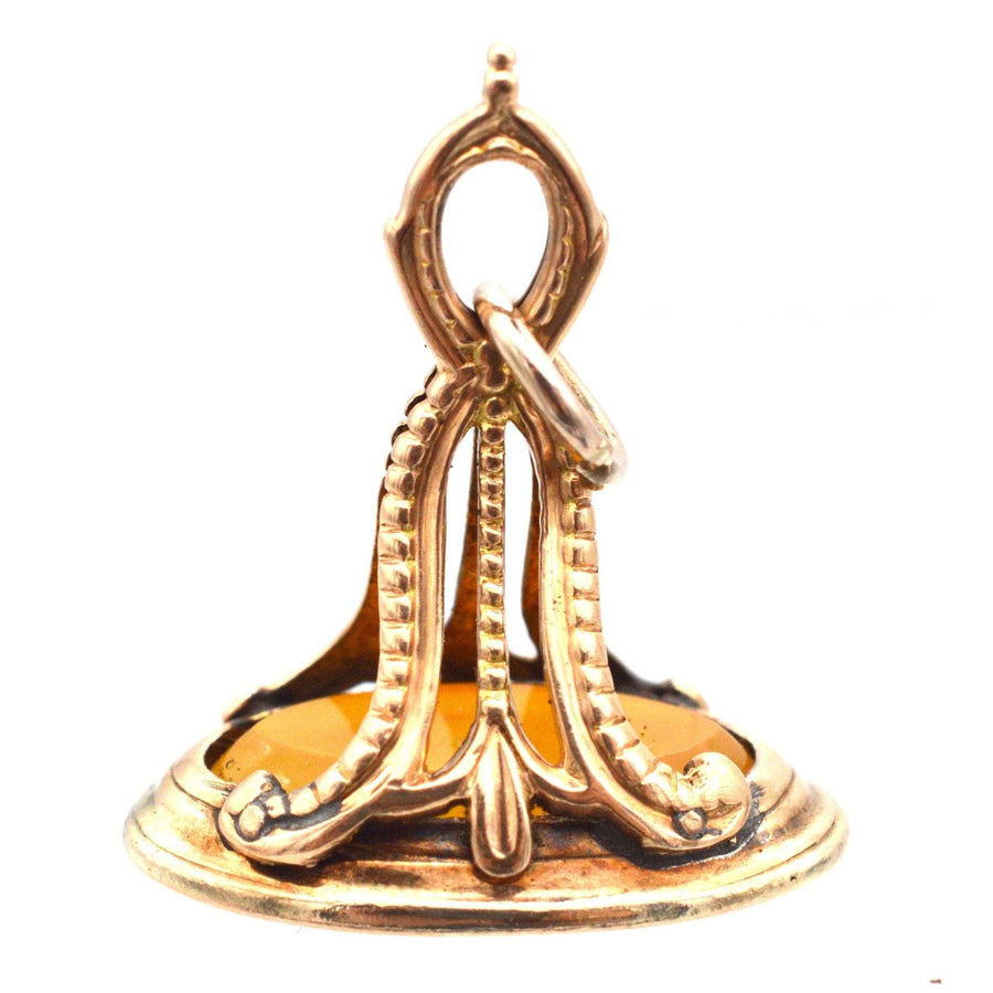 Georgian 9ct gold carnelian seal featuring intaglio moth and candle design from 1800s.