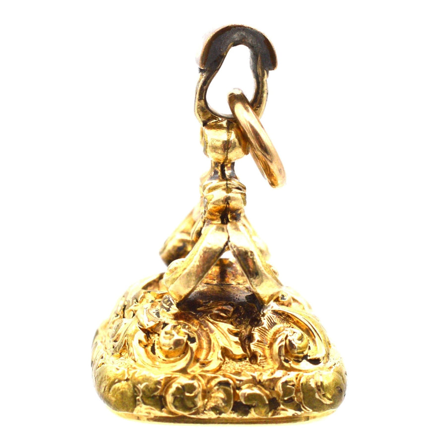 Georgian gold cased seal with intricate details and loop, featuring a citrine intaglio of the monogram 'SC'.
