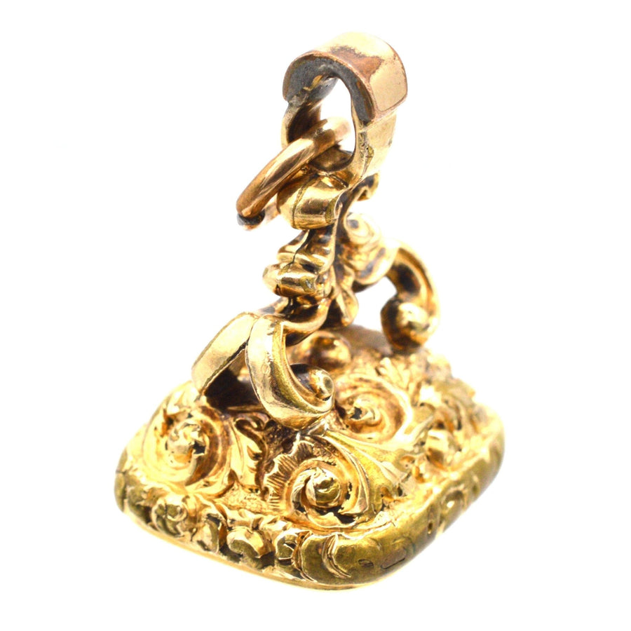 Georgian gold cased seal featuring intricate decorations and a citrine intaglio monogram 'SC'.