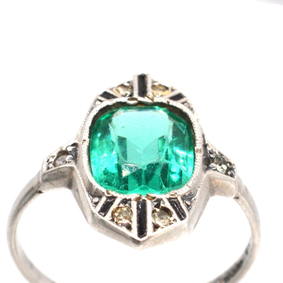 German Art Deco silver cocktail ring featuring emerald green paste stone and white diamond paste accents.