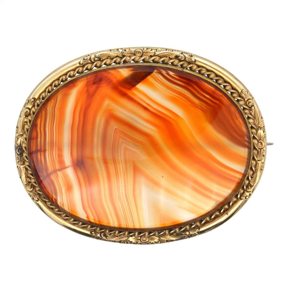 Large Victorian 9ct gold brooch featuring striking banded agate with vibrant orange hues.