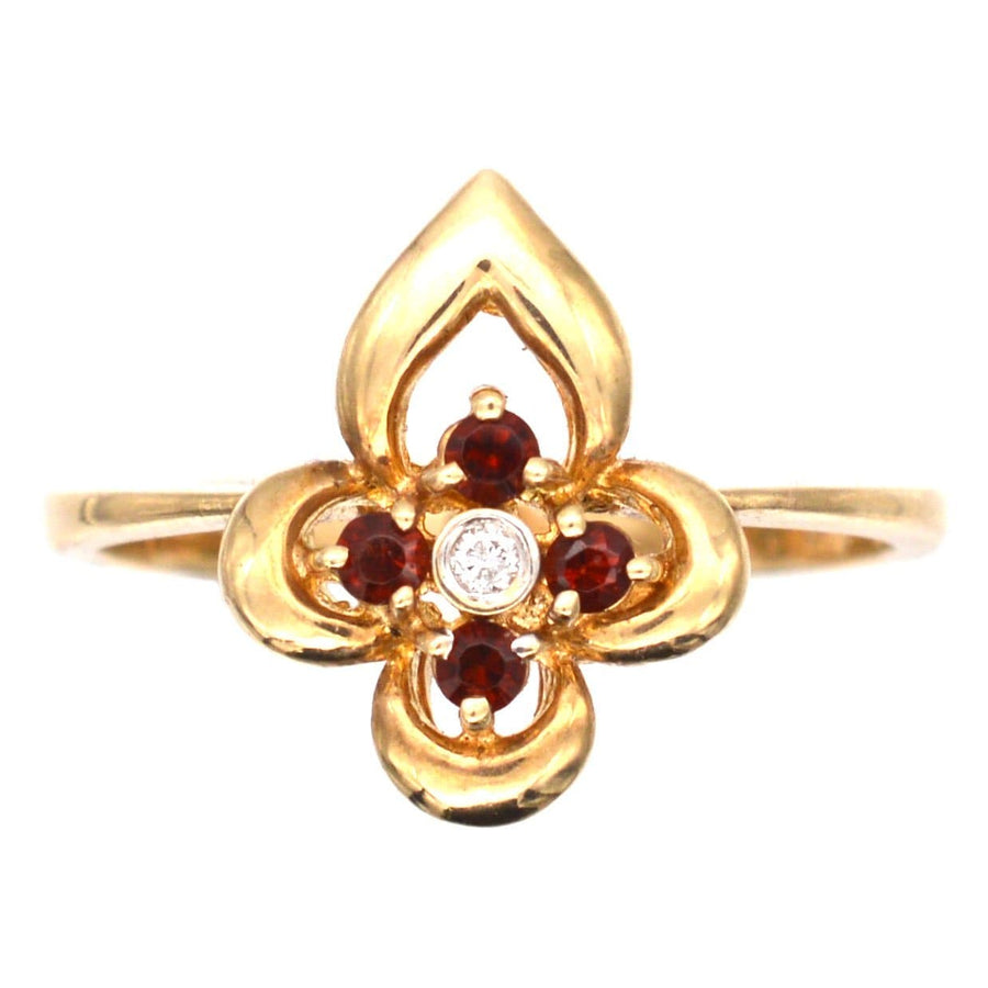 Late 20th Century 18ct gold ring featuring hessonite garnets and a diamond, showcasing floral design in warm tones.