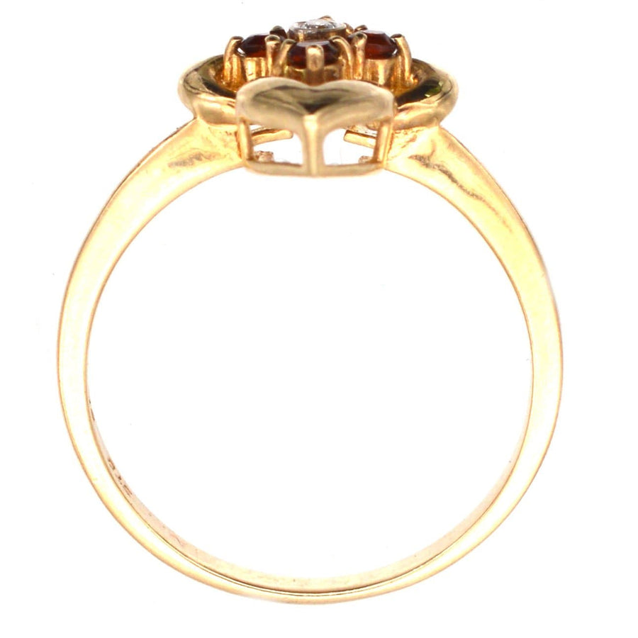 18ct gold ring featuring hessonite garnets and a diamond, showcasing unique cinnamon stone design.