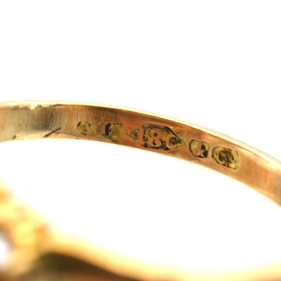 Close-up of 18ct gold hallmark on a Late Victorian ring, showcasing vintage craftsmanship.