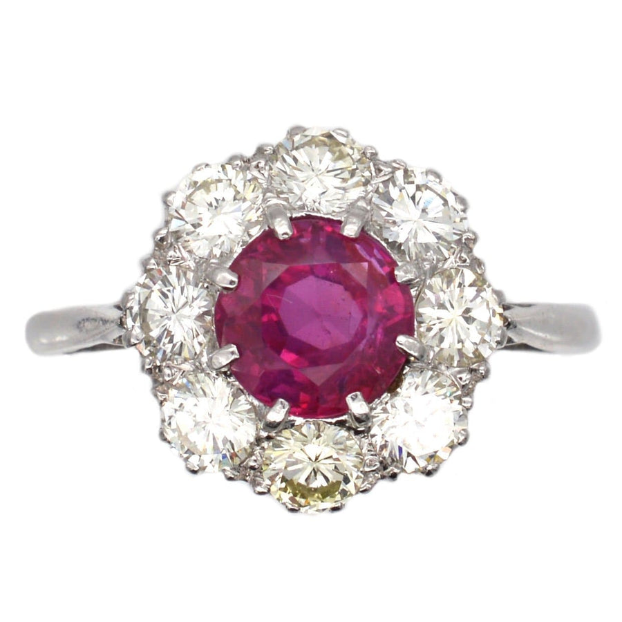 Mid 20th Century platinum cluster ring featuring a 1.7 carat Burma ruby surrounded by eight sparkling diamonds.