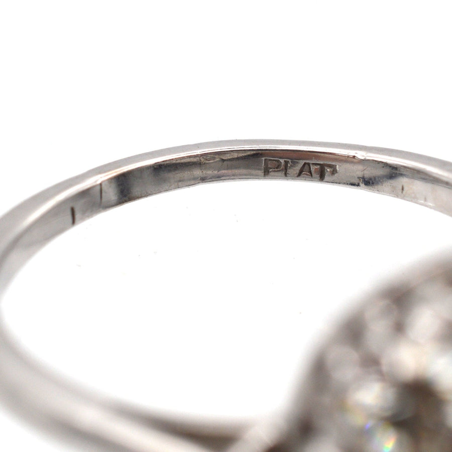 Close-up of the interior band of a platinum ring, featuring the engraved hallmark 'PLAT'.