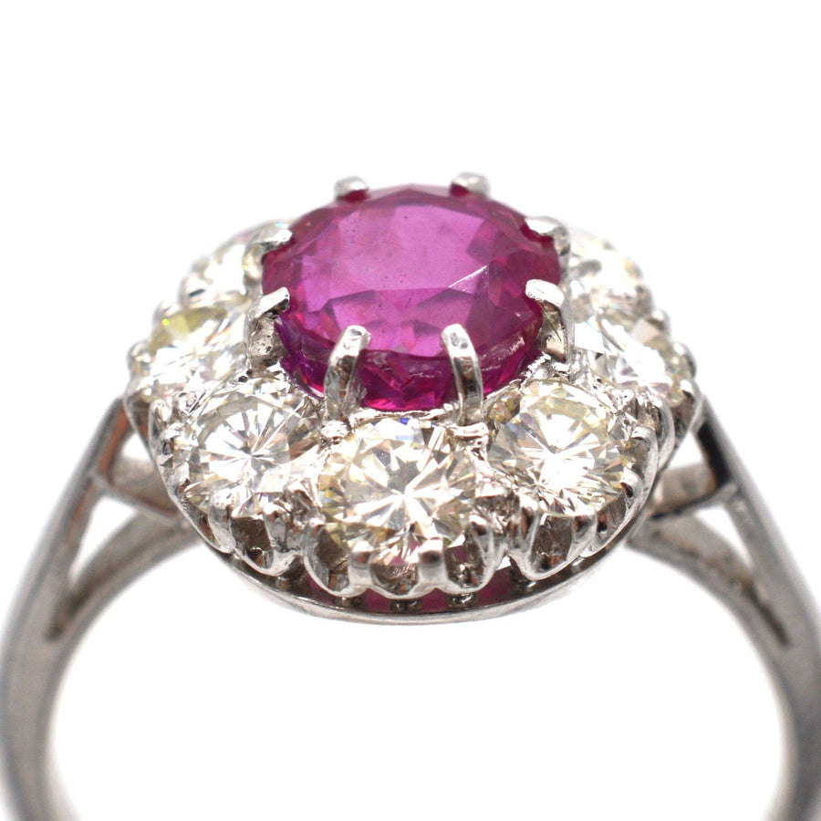Mid 20th Century platinum ring featuring a 1.7 carat Burma ruby surrounded by eight diamonds.
