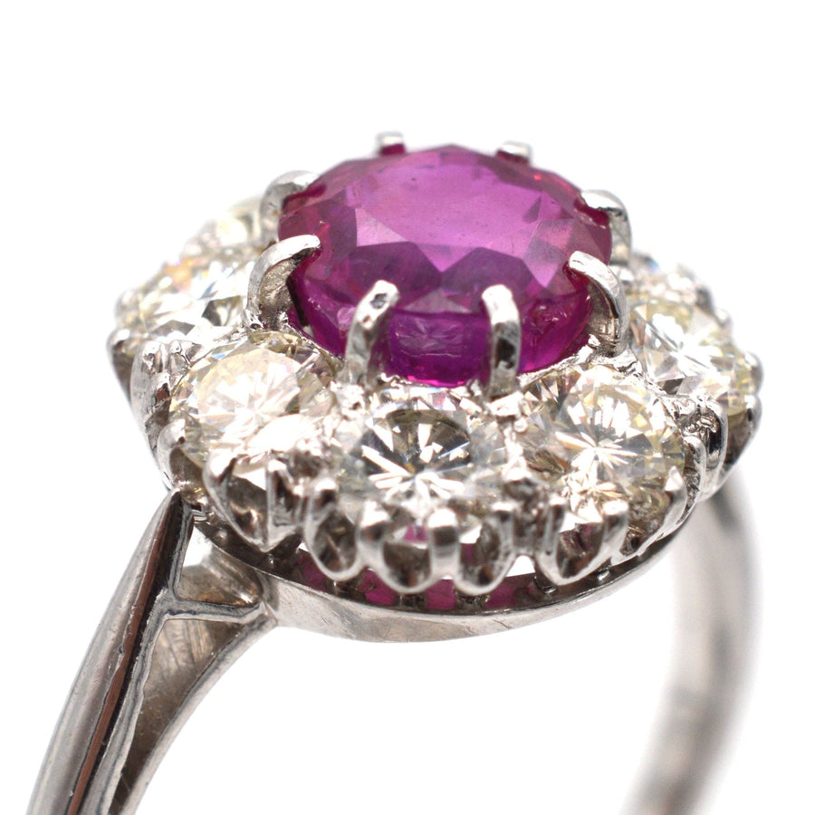 Mid 20th century platinum ring featuring a 1.7 carat Burma ruby surrounded by eight stunning diamonds.